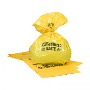 A yellow clinical waste bag with the words 'contaminated waste' pirnted on it in black writting and a black biohazard symbol